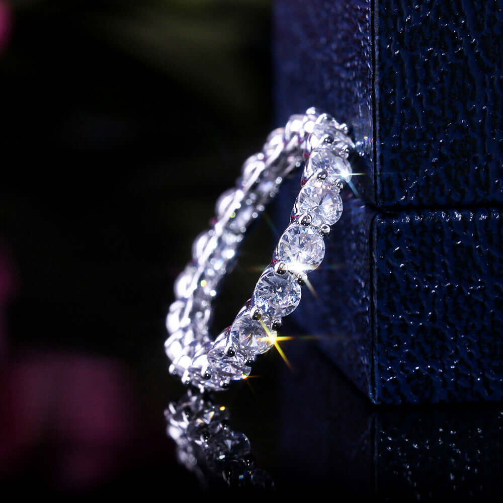 Luxury copper plated platinum ring adorned with sparkling oval and round zircons, reflecting light elegantly.