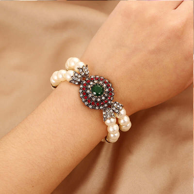 Luxury pearl bracelet featuring alloy and a striking gem centerpiece, perfect for elegant occasions.