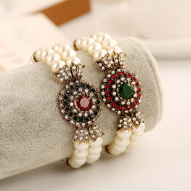 Luxury pearl bracelet featuring alloy accents with red and green gemstones, perfect for elegant occasions.