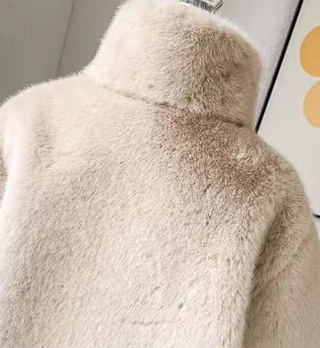 Back view of a luxury children's fur coat in apricot color, featuring a soft texture and mid-length design.
