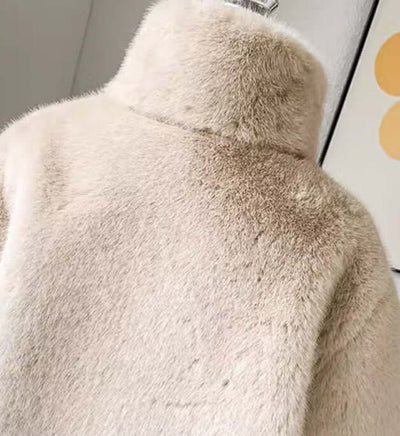 Back view of a luxury children's fur coat in apricot color, featuring a soft texture and mid-length design.